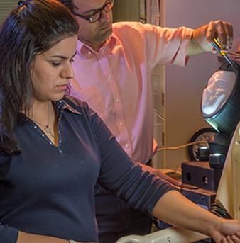 Students and professors work in a lab.